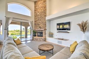 a living room with a couch and a fireplace at Fountain Hills Home with Pool, Spa and Putting Green! in Fountain Hills