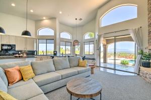 a living room with a couch and a table at Fountain Hills Home with Pool, Spa and Putting Green! in Fountain Hills