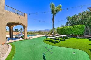 a golf course with a green with a table and benches at Pool, Spa and Putting Green Fountain Hills Home! in Fountain Hills