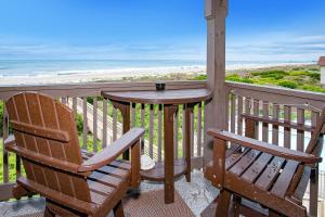 a table and chairs on a balcony with the beach at Southwinds II in Atlantic Beach