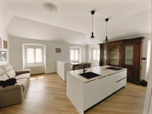 a kitchen with a white island in a living room at Appartamento Villa Cristina in Genoa