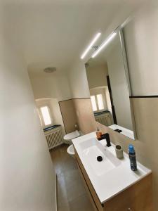 a bathroom with a white sink and a mirror at Appartamento Villa Cristina in Genova