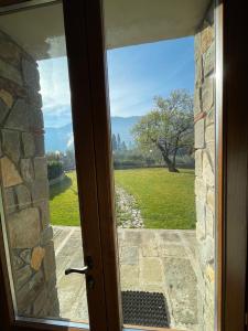 an open door with a view of a field at Affittacamere Il Vecchio Mandorlo in Quarrata