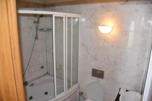 a bathroom with a shower and a toilet at Dinara Hotel in Kemer
