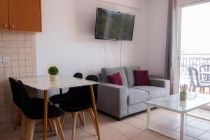 a living room with a couch and a table at Amelia Two Bedroom Apartment - 202 in Paphos City