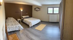 a bedroom with a bed and a table and a window at Villa avec piscine dans Vallon Pont d’Arc in Vallon-Pont-dʼArc +24 photos