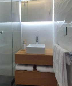 a bathroom with a sink and a mirror and towels at COCO in Veliko Gradište