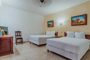 Postel nebo postele na pokoji v ubytování Hotel Santa María Mérida