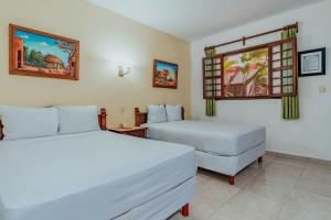 Postel nebo postele na pokoji v ubytování Hotel Santa María Mérida