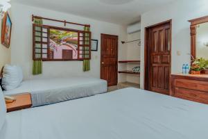 Postel nebo postele na pokoji v ubytování Hotel Santa María Mérida