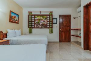 Postel nebo postele na pokoji v ubytování Hotel Santa María Mérida