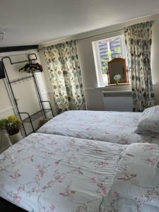 a bedroom with a bed and a window at The Red Lion Great Offley in Great Offley