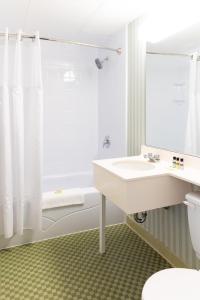 a bathroom with a sink, toilet and shower at Rodd Grand Yarmouth in Yarmouth