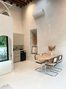 a kitchen with a table and chairs in a room at Atelier Lumi at Lumicollection in Miami
