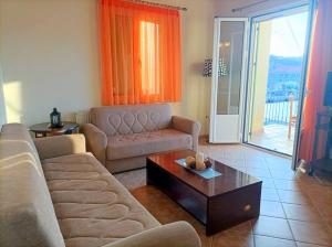 a living room with a couch and a coffee table at Lourantos Bayside Apartments in Vathi