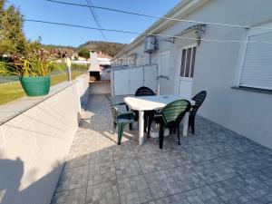 a patio with a table and chairs on a house at 2 bedrooms house with sea view enclosed garden and wifi at Marinhas in Marinhas