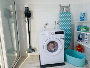 a washing machine in a bathroom with a shower at Blue House Mallorca in Ses Salines