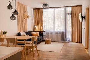 ein Wohnzimmer mit Tisch und Couch in der Unterkunft Almara - Family Apartment in Bad Goisern