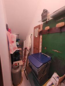 a small room with a toilet and a green door at Casa Vacanze Triscina (Trapani) in Triscina
