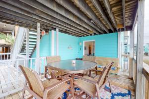 a dining room with a table and chairs on a balcony at Lani Kai 130 in Gulf Shores