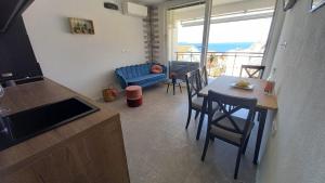 a kitchen and living room with a table and chairs at Seaview Suites Ondina in Komiža