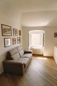 a living room with a couch and a window at Appartamento Villa Cristina in Genoa