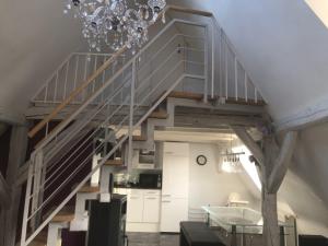 a staircase in a loft conversion with a dining room and kitchen at Dachgeschosswohnung-15min vom Europa Park entfernt in Kenzingen