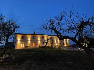 a building with lights on it at night at Agriturismo La Casa dei Ricordi in Collesalvetti