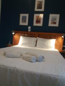 a large white bed with two rolled towels on it at apartment in poros in Poros