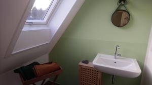 a bathroom with a sink and a window at Baumwipfel in Hohwacht