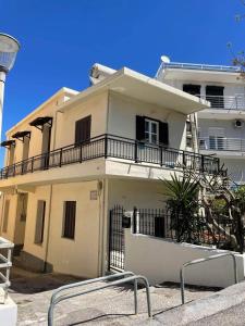 a white house with a balcony on top of it at Casa Dino Bello in Rhodes Town