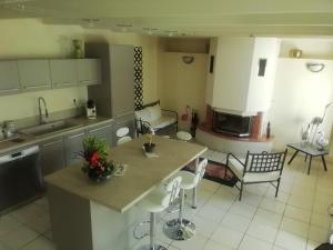 a kitchen and living room with a table and chairs at La maison au bord de l'eau in Plouigneau