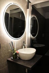 a bathroom with a white sink and a mirror at BeTurin in Turin