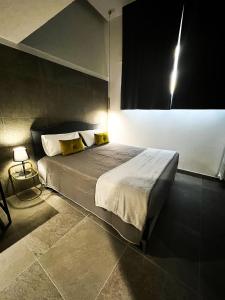a bedroom with a large bed with yellow pillows at BeTurin in Turin
