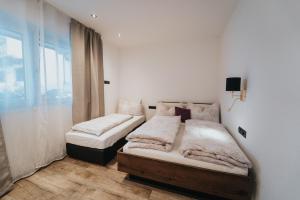 Un pat sau paturi într-o cameră la Apartklusiv Kaltenbach