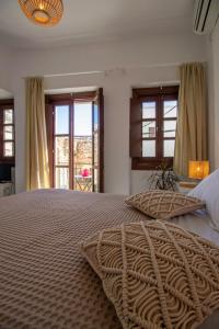 a bedroom with a large bed with a large blanket at Platsa's House in Apeiranthos
