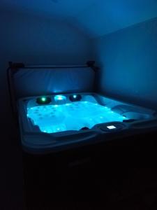 a blue tub with lights in a dark room at Chambre de Brunemont in Diéval