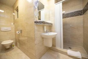 a bathroom with a toilet and a sink and a shower at Old Prague Hotel in Prague +37 photos