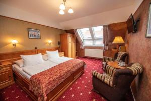 a hotel room with a bed and a chair at Old Prague Hotel in Prague