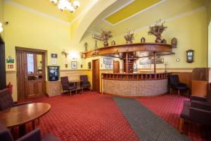 a bar in a pub with tables and chairs at Old Prague Hotel in Prague