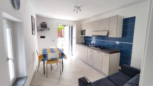 a kitchen and dining room with a table and a couch at Uliveto in Diano San Pietro +45 photos