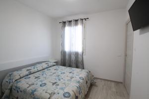Krevet ili kreveti u jedinici u objektu Appartamenti LE TRE ISOLE con Terrazza Vista Mare
