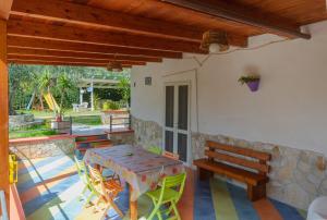 a patio with a table and chairs and a bench at B&B Tor Di Lupo in Mattinata