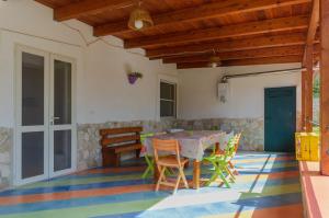a dining room with a table and chairs on a colorful floor at B&B Tor Di Lupo in Mattinata