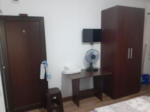 a bedroom with a desk and a cabinet and a television at Kociu's House in Constanţa +15 photos