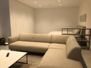 a living room with a couch and a bed at Garou in Luxembourg