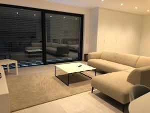 a living room with a couch and a table at Garou in Luxembourg