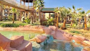 a pool in a resort with rocks in the water at Blue Bay Asia Sokhna Aqua park بلو باي اسيا العين السخنه - عائلات فقط in Ain Sokhna