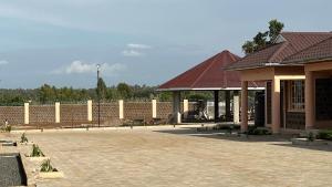 a building with a pavilion and a brick wall at Dala Luxury Home- Bondo in Bondo