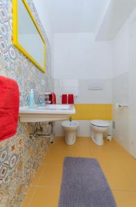 a bathroom with a sink and a toilet at B&B Tor Di Lupo in Mattinata